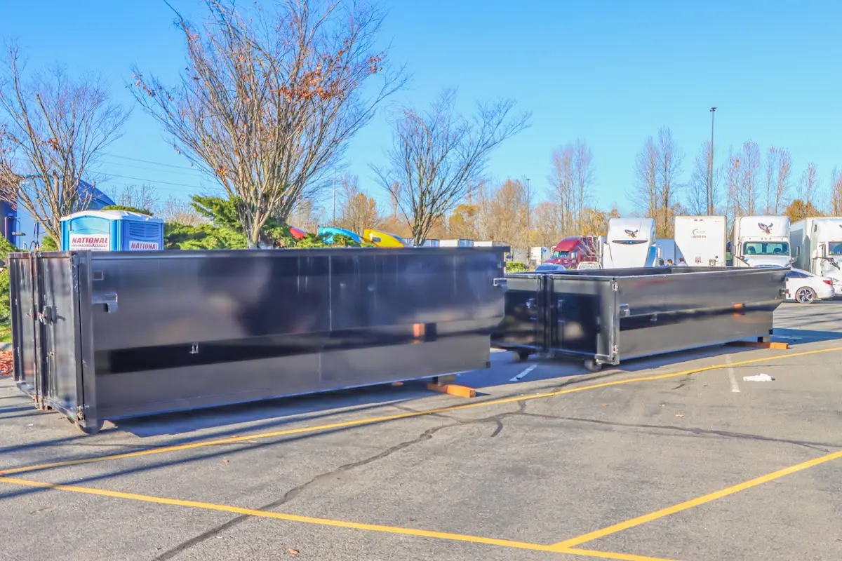 Professional dumpster rental service with roll-off container on residential driveway in Sultan